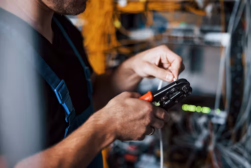 Technician fitting magnetic sensors to rolling shutter track